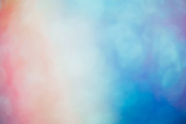 Defocused color glow. Bokeh light. Rainbow reflection. Blur orange blue purple gradient lens flare spots on abstract empty space background.