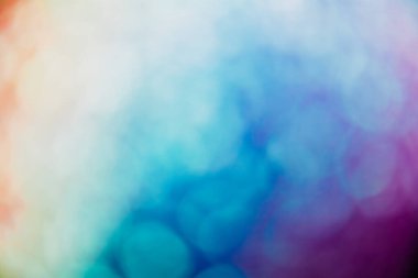 Bokeh light background. Blur glow. Solar radiance. Defocused orange blue purple circles flare on color gradient abstract copy space texture.