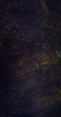 Particles texture. Blur sparks. Bokeh light. Cosmic dust. Defocused purple orange color sparkles on dark black futuristic abstract banner.