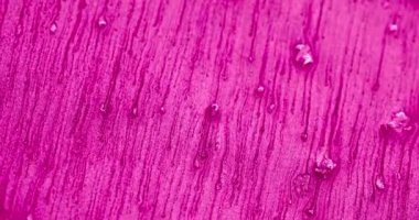 Glitter background. Color sand flow. Sparkles wave. Defocused neon pink rose violet particles fluid drip motion abstract grain texture. Shot on RED Cinema camera.