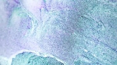 Vertical video. Glitter wave. Particles background. Sea foam. Iridescent green purple black white color shimmering fluid mix splash abstract texture. Shot on RED Cinema camera.
