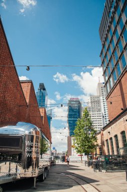 Warsaw, Poland - June 22, 2022: Landmark architecture. City view. Norblin factory. Modern and old buildings on summer street in sunlight day.