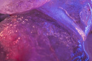 Water glitter pollution. Microplastic danger. Environmental disaster. Pink purple toxic textured melting ice