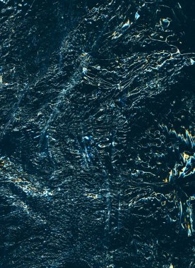 Worn abstract background. Creased texture. Crumpled plastic film. Blue orange white ripples on gritty dark black illustration overlay.
