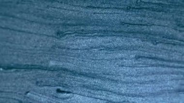 Vertical video. Glitter fluid flow. Shiny particles texture. Sparkles wave. Tranquil blue color shimmering sand motion abstract background. Shot on RED Cinema camera.
