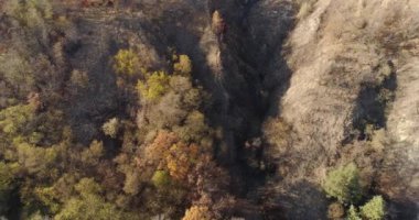 Landscape soil erosion. Aerial view of hills rough terrain and broken ground with trees
