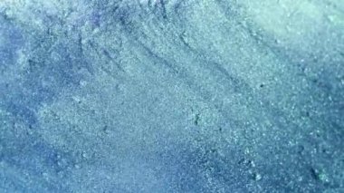 Vertical video. Particles background. Glitter texture. Floating dust. Tranquil blue color shiny bubbles motion abstract grain surface for intro. Shot on RED Cinema camera.