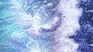 Vertical video. Particles background. Glitter wave. Ocean foam. Iridescent blue purple white color gradient shiny water splash abstract grain texture. Shot on RED Cinema camera.