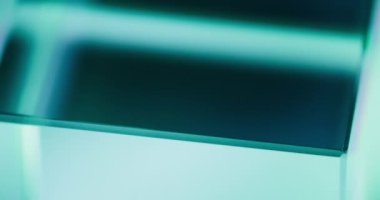 Neon light background. Glass cube rotation. Defocused fluorescent verdigris green blue color glow abstract free space for logo. Seamless loop. Shot on RED Cinema camera.