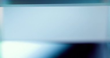 Glowing geometric background. Glass cube rotation. Defocused neon tranquil blue white color light abstract copy space for text. Seamless loop. Shot on RED Cinema camera.