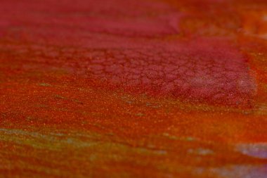 Paint blend. Artistic hobby. Colorful abstract bakground. Red orange glitter paints mix