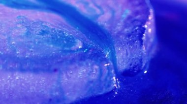 Global warming. Melting blue ice macro shot. Natural crystal clear flowing water. Creative background