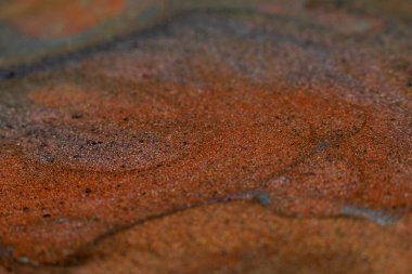 Sıvı mürekkep. Çok renkli simli arka plan. Kahverengi kum etkisi