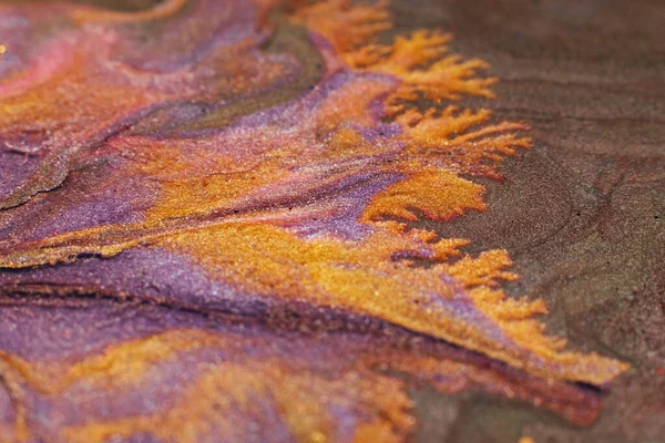 Abstract painting. Acrylic magic. Creative art. Purple orange liquid glitter blend