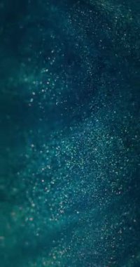 Bokeh simli girdap. Parçacık arkaplanı. Bulanık daireler hareketi. Odaklanmamış mavi turuncu renkli köpükler karanlık ve soyut dokular. Dikey video. RED Sinema Kamerasında Çekim.