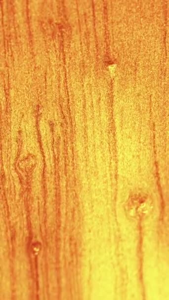 Vertical Video Golden Glitter Texture Shimmering Liquid Flow Yellow Sparkles — Stock Video