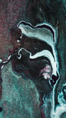 Vertical video. Glitter fluid wave. Marble gradient. Shiny particles texture. Green white color liquid flow abstract background. Shot on RED Cinema camera.