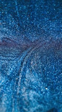 Vertical video. Particles background. Glitter fluid. Sparkles flow. Defocused blue color shiny ink wave abstract grain texture for intro. Shot on RED Cinema camera.