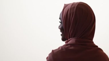 Doğulu bir kadın. Kadın güzelliği. Mutlu portre. Beyaz arka planda tesettürlü güzel mutlu bayan uzun kamçı görünümlü kopya alanı.