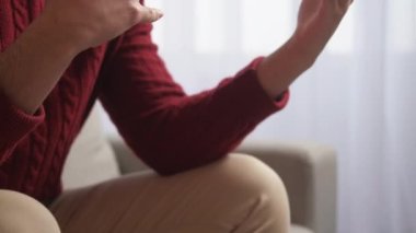 Duygusal bir konuşma. Danışma toplantısı. Psikoterapi desteği. Tanımlanamayan endişeli adam el hareketleriyle koltukta oturuyor..