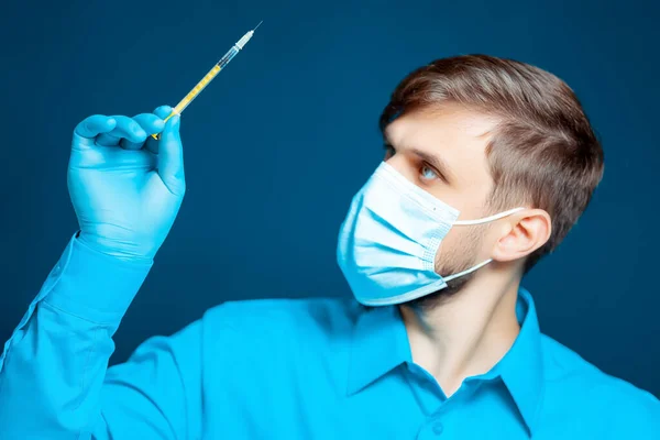 Médico Máscara Médica Luvas Uniforme Azul Está Segurando Uma Seringa — Fotografia de Stock