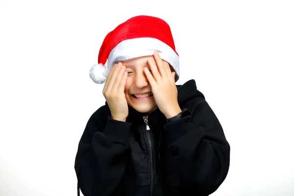 Boy Red Santa Hat Holds Covers His Eyes His Hands — Stock Photo, Image