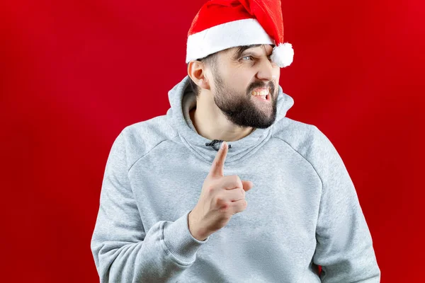 Man Red Santa Claus Hat Beard Stands Red Christmas Background — Stock Photo, Image