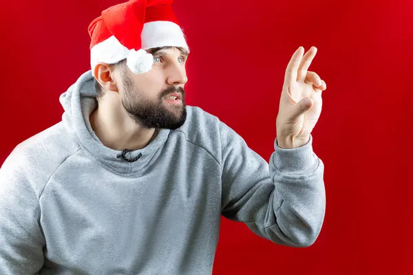 Een Man Een Rode Kerstman Hoed Staat Zijwaarts Wil Het — Stockfoto