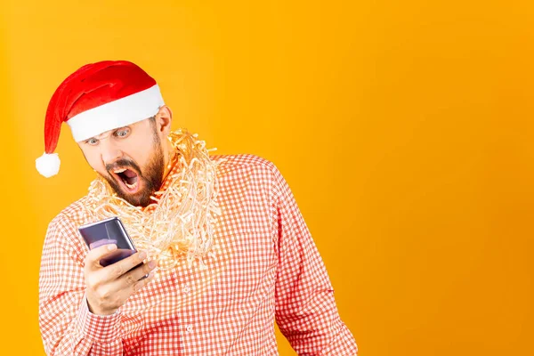 Ein Mann Mit Roter Nikolausmütze Auf Gelbem Grund Schaut Die — Stockfoto