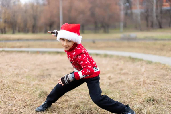 Boy Warm Christmas Sweater New Year Deer Santa Hat Performs — Stock Photo, Image