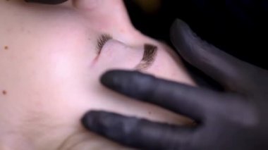 Kalıcı kaş makyajı sürecinin makroskobu kalıcı makyaj ustası kaş dövmesi yapar.