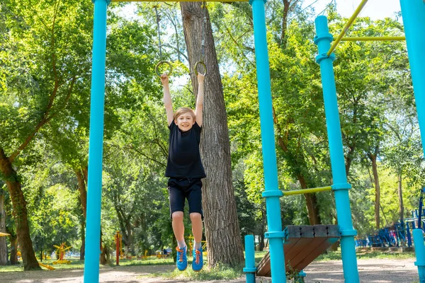 Boy Goes Sports Park Hangs Gymnastic Rings Tries Pull Himself — Stock Photo, Image