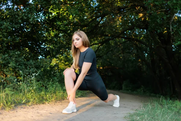 Blond Sports Girl Performs Elements Stretching Legs Tilting Leaning Leg — стоковое фото