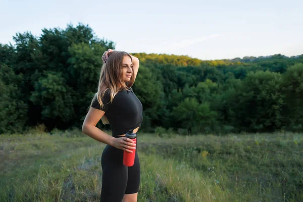 Blonde Sportswoman Park Posing Red Bottle Water Sunset —  Fotos de Stock