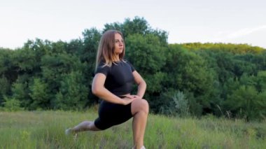 sportswoman stretching her legs in the park