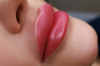 close-up of the lips and with the implementation of permanent makeup using a typewriter