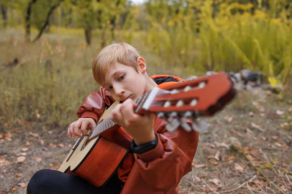 Boy Outdoors Autumn Park Playing Guitar — Stock Photo, Image