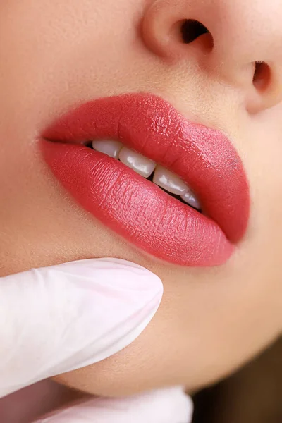 macro photography of permanent lip makeup made with red pigment