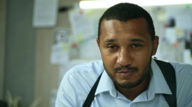 Close up of handsome detective talking at camera. Portrait of african american police officer telling, sharing experiences of his work with audience. FBI agent giving interview or master class