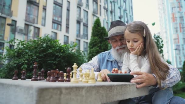 Lovely Granddaughter Teaches Grandpa Use Mobile Phone Outdoor Cute Little — Stock Video