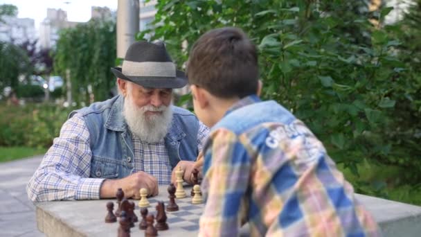 Smart Happy Little Child Boy Checkmate His Caring Old Senior — Stok video