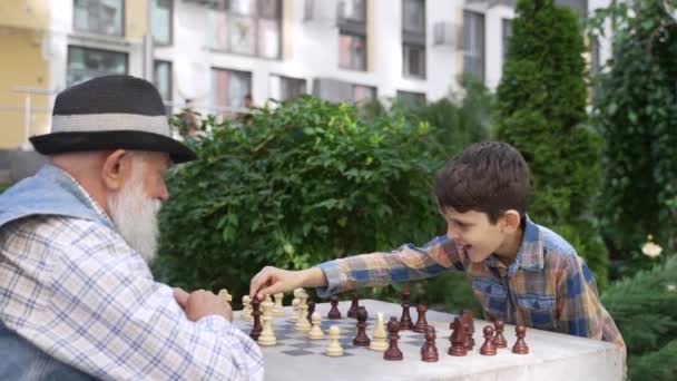 Brilliant Happy Child Boy Checkmating Grandfather Checkmate His Caring Old — Stockvideo