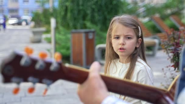 Portrait Serious Pretty Little Girl Singing Accompaniment Guitar Outdoor Cute — Vídeo de Stock