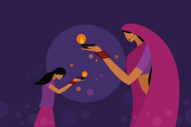 Geleneksel elbise giyen bir anne ve kız Diwali festival lambaları taşıyor. Hindistan 'daki Diwali festivali için kavram