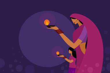 Geleneksel elbise giyen bir anne ve kız Diwali festival lambaları taşıyor. Hindistan 'daki Diwali festivali için kavram