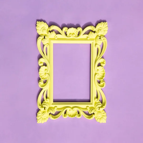Vintage yellow frame on pastel purple background. Trendy old fashion concept. Modern contrast composition.