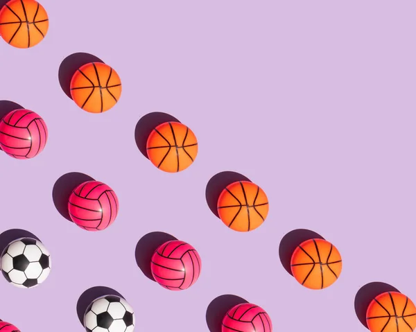 Creative sport concept. Colorful balls on pastel bright purple background. Minimalistic education composition with copy space.