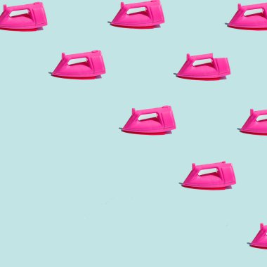Trendy pattern with pink steam iron on pastel bright blue background. Creative housekeeping concept with copy space.