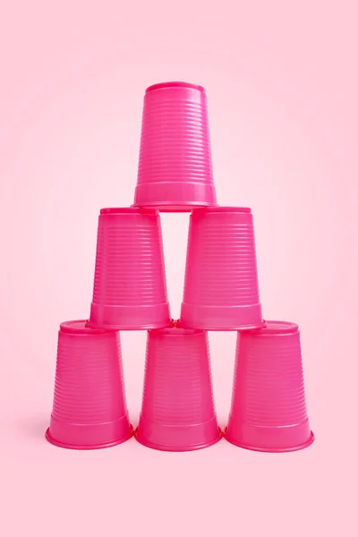 stacking game with pink stacked cups and pink background