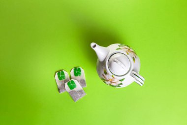 top view of tea set and teapot on green background